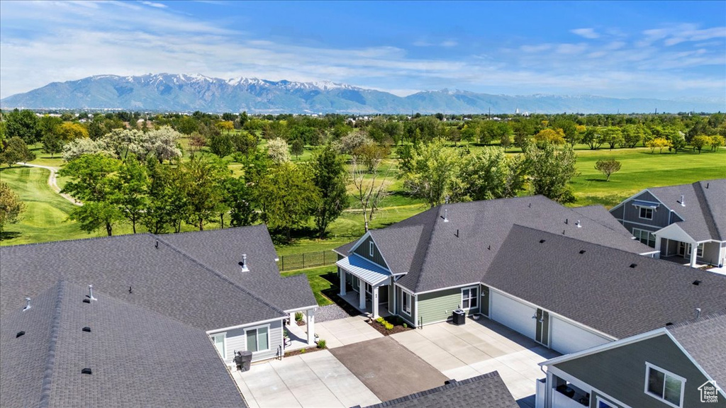 Drone / aerial view of a mountainous background and a golf course