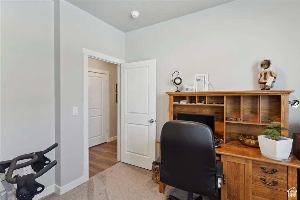 Carpeted office space with baseboards