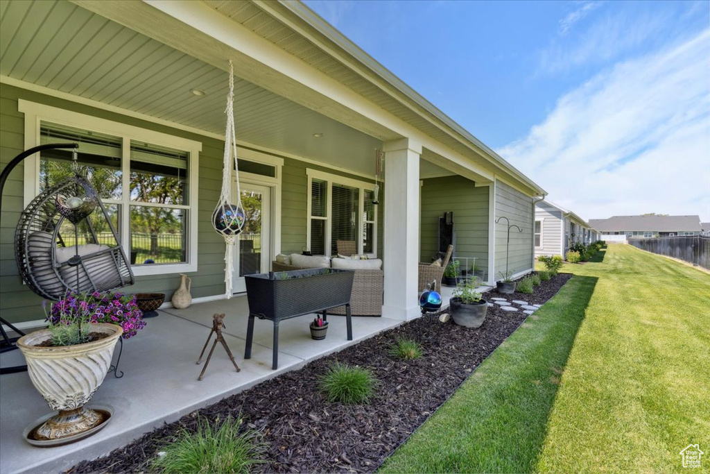 Porch featuring a lawn