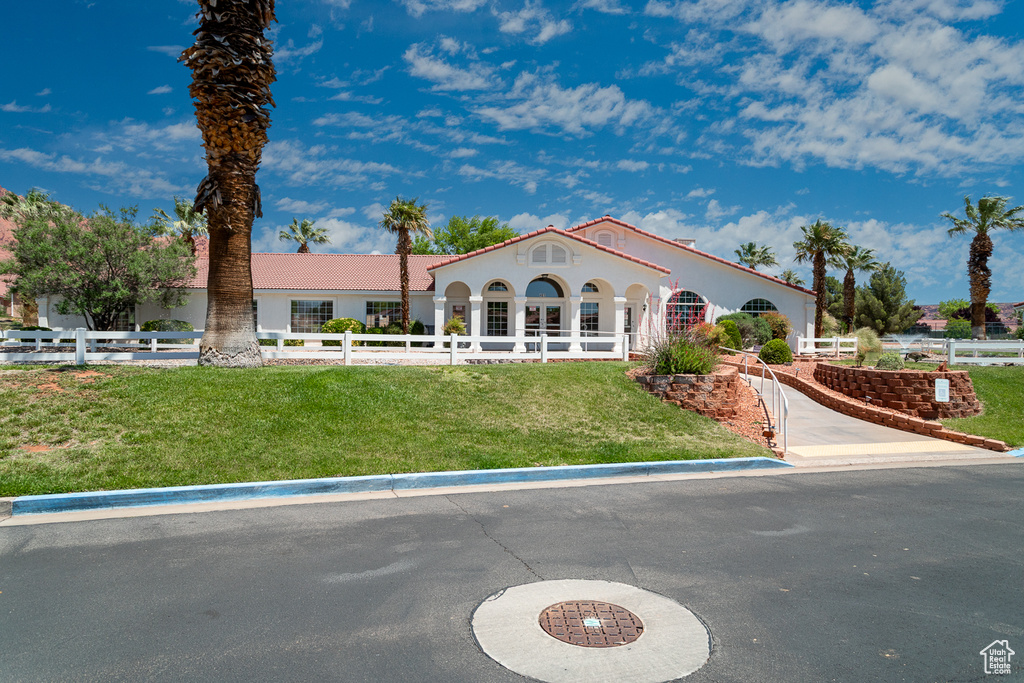 View of front of property with a tile roof and stucco siding