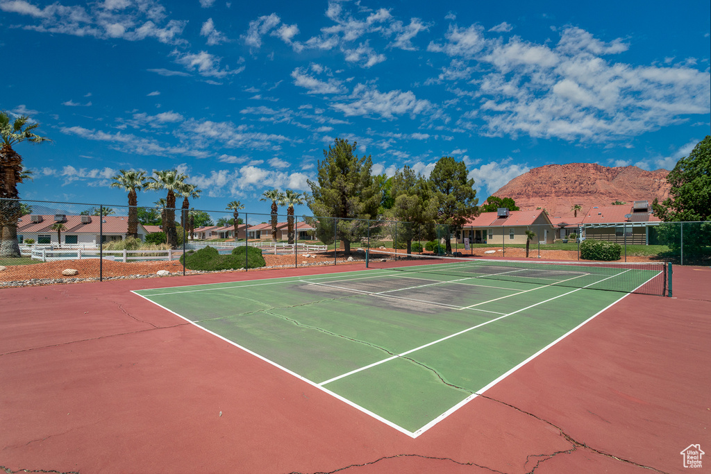 View of tennis court with community basketball court and a mountain view