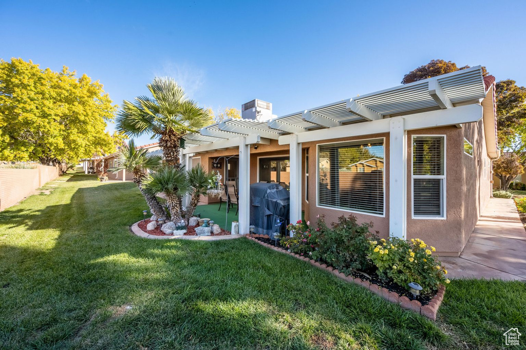 Rear view of house with a pergola, stucco siding, a chimney, and a patio