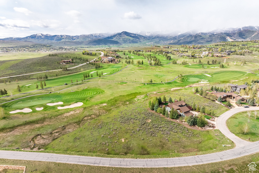 Drone / aerial view of a mountainous background and a golf club