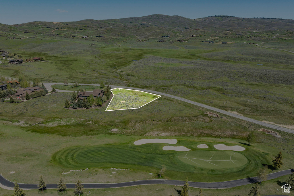 View of property location featuring property parcel outlined, a mountain backdrop, and a local golf course