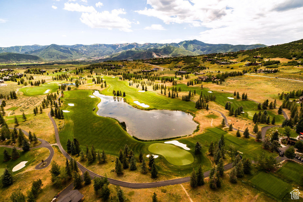 Aerial overview of property's location with a water and mountain view and a golf course