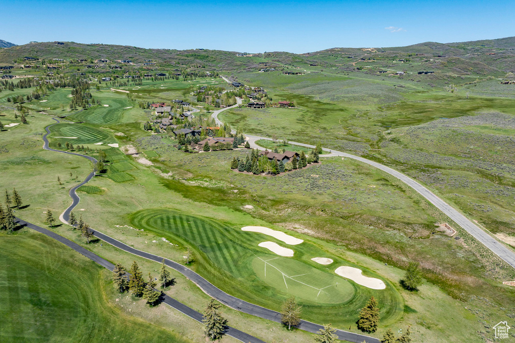 View of property location featuring a mountain backdrop and a golf course