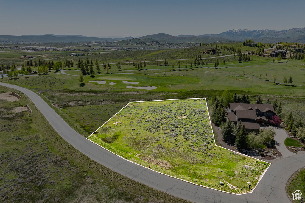 Aerial overview of property's location featuring property parcel outlined and a mountain backdrop