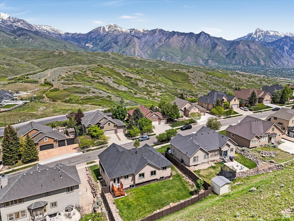 Aerial perspective of suburban area featuring a mountainous background