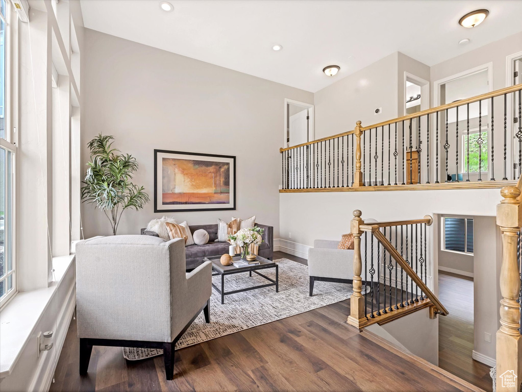 Living area with wood finished floors, recessed lighting, and baseboards