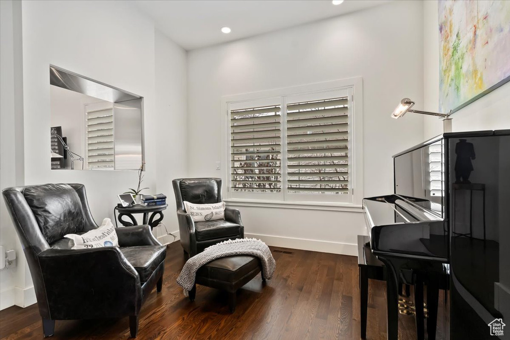 Living area with wood finished floors, baseboards, recessed lighting, and plenty of natural light