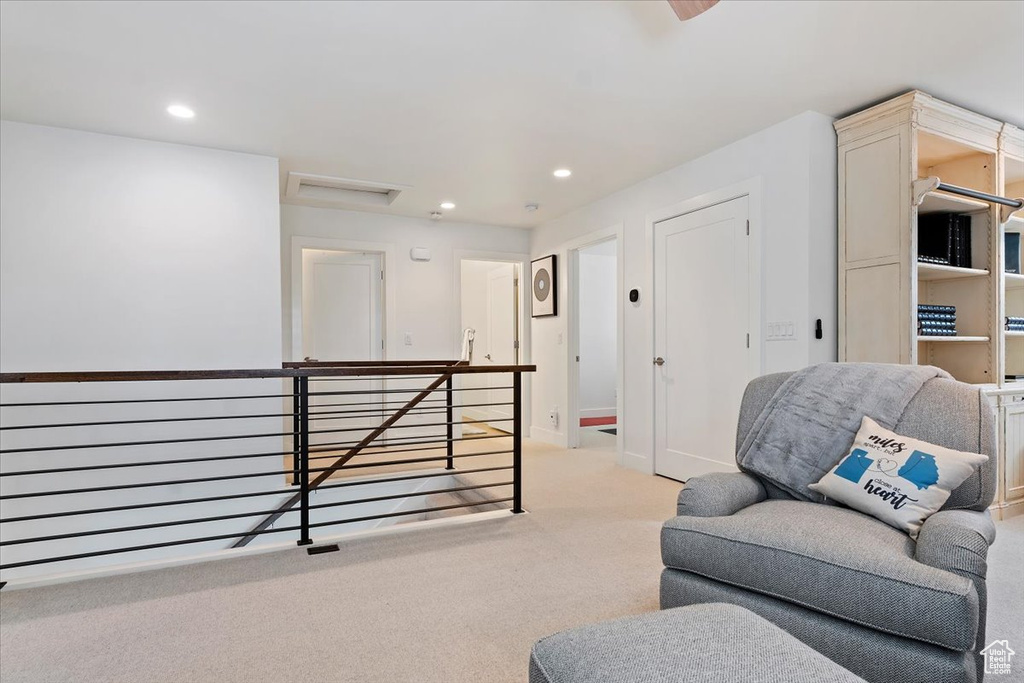 Living area featuring an upstairs landing, carpet, recessed lighting, attic access, and baseboards