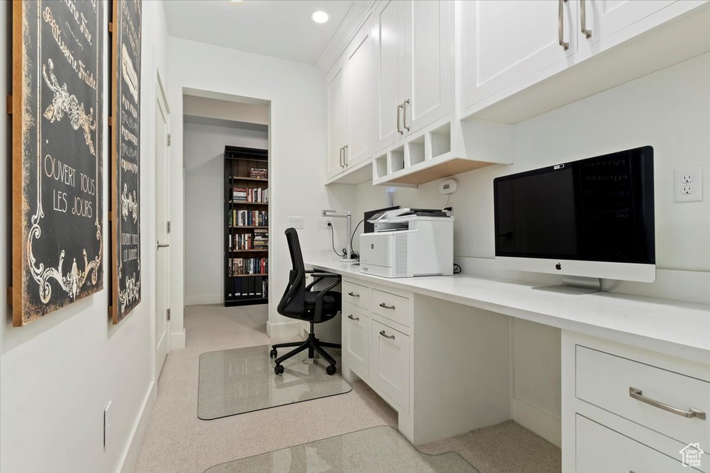 Office area featuring built in study area, light colored carpet, baseboards, and recessed lighting