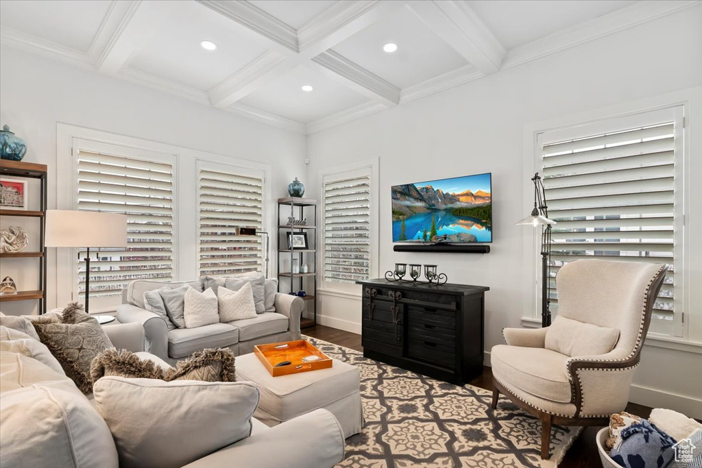 Living room with coffered ceiling, wood finished floors, recessed lighting, beam ceiling, and baseboards