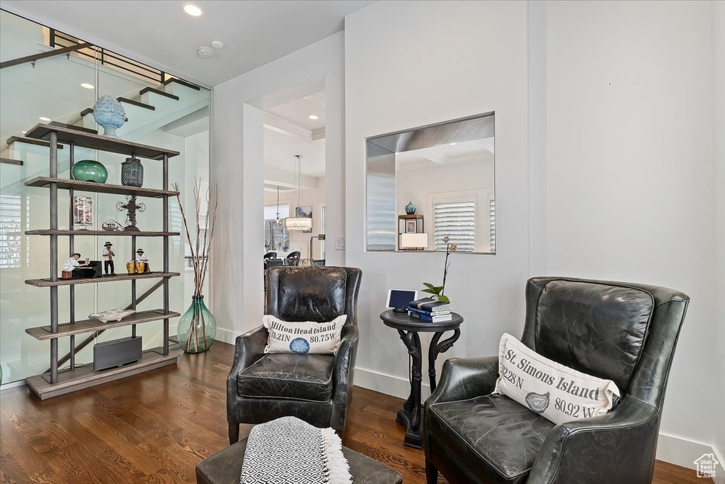 Living area featuring wood finished floors, baseboards, stairs, and recessed lighting