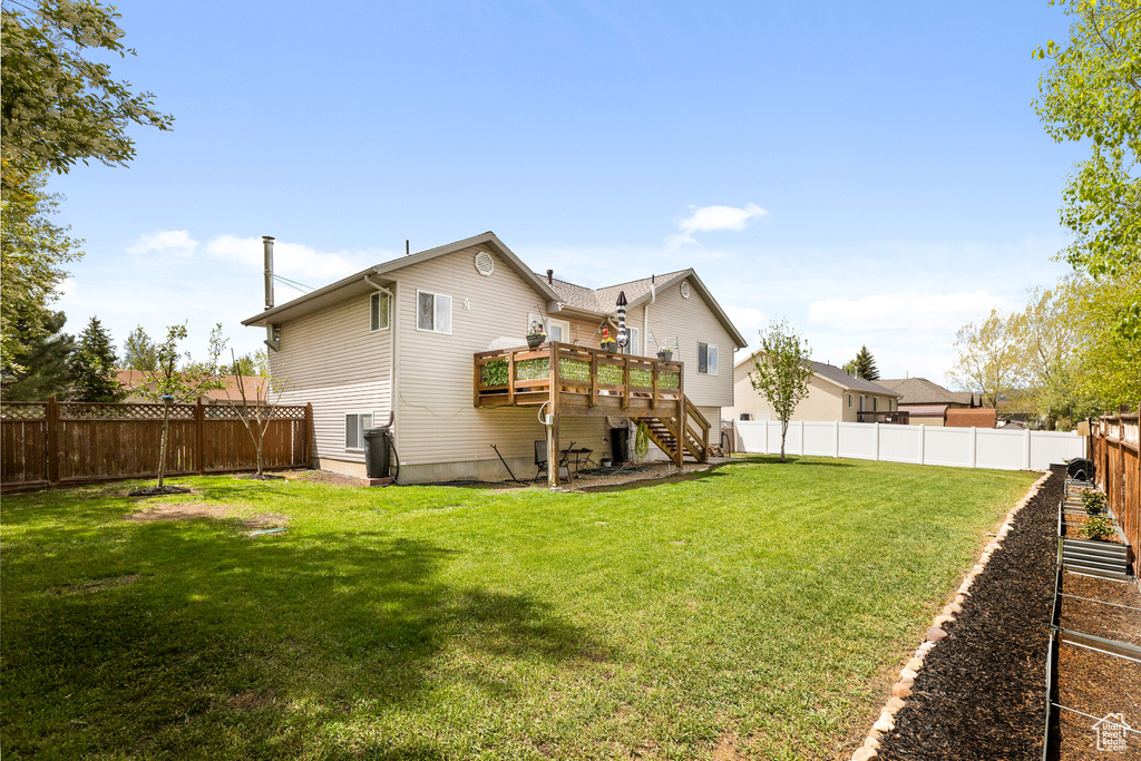 Rear view of property with stairs and a deck