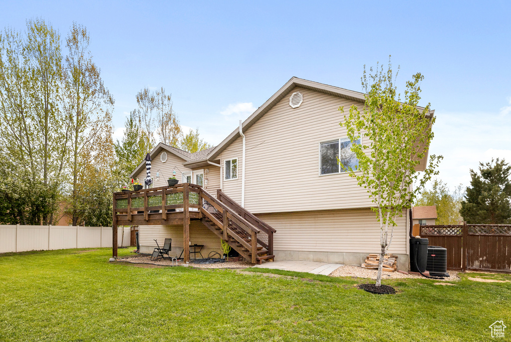 Rear view of house featuring stairs, a wooden deck, and central air condition unit