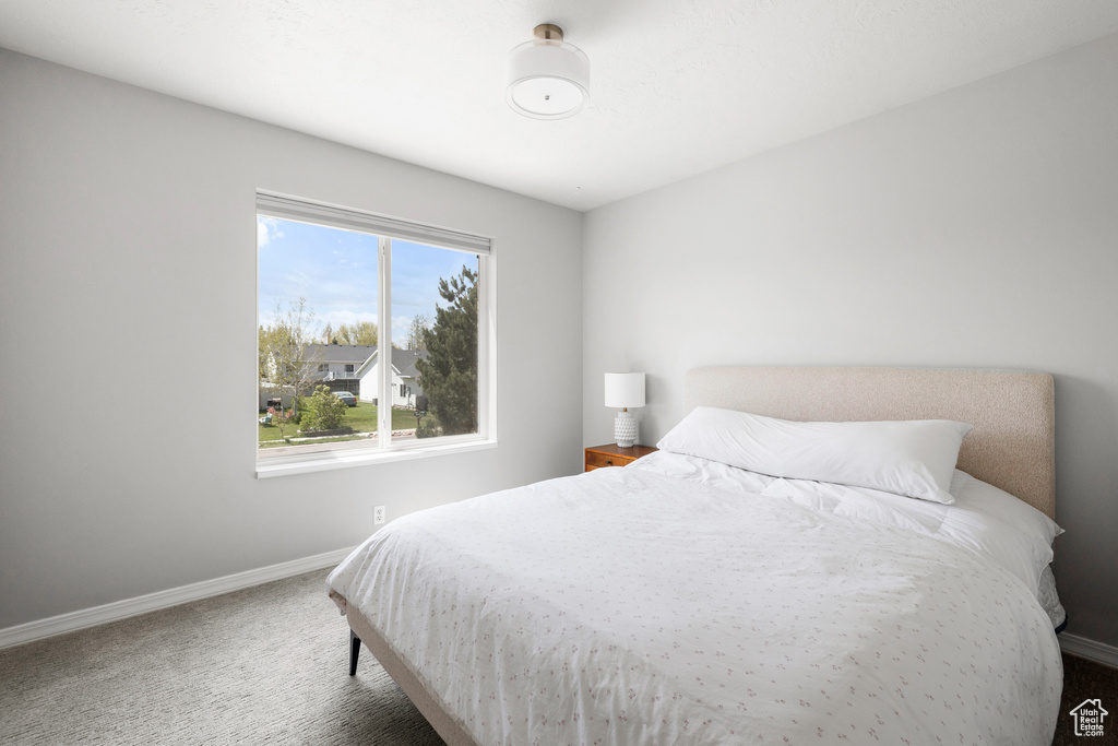 Carpeted bedroom featuring baseboards