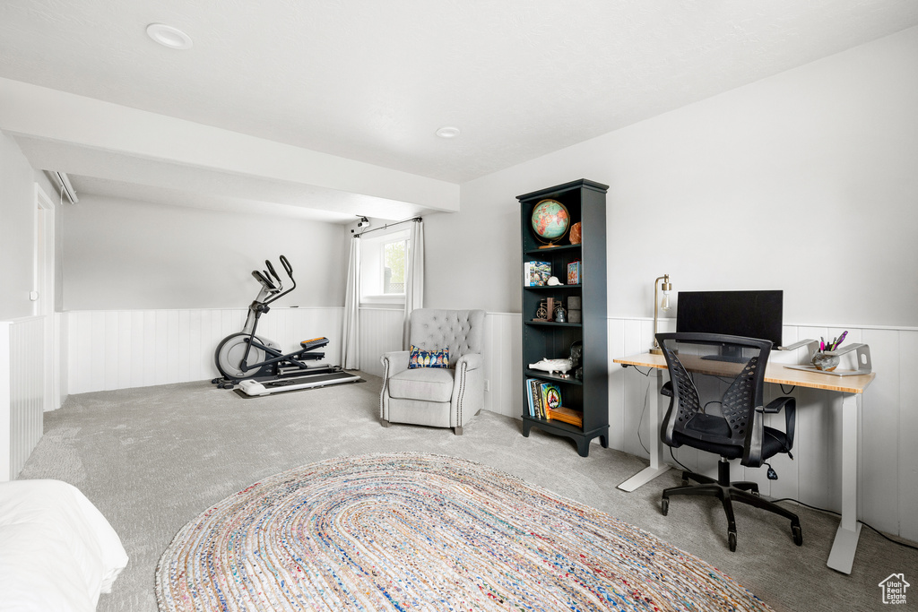 Carpeted home office featuring a wainscoted wall