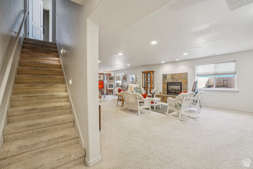 Staircase with carpet, recessed lighting, baseboards, and a tile fireplace