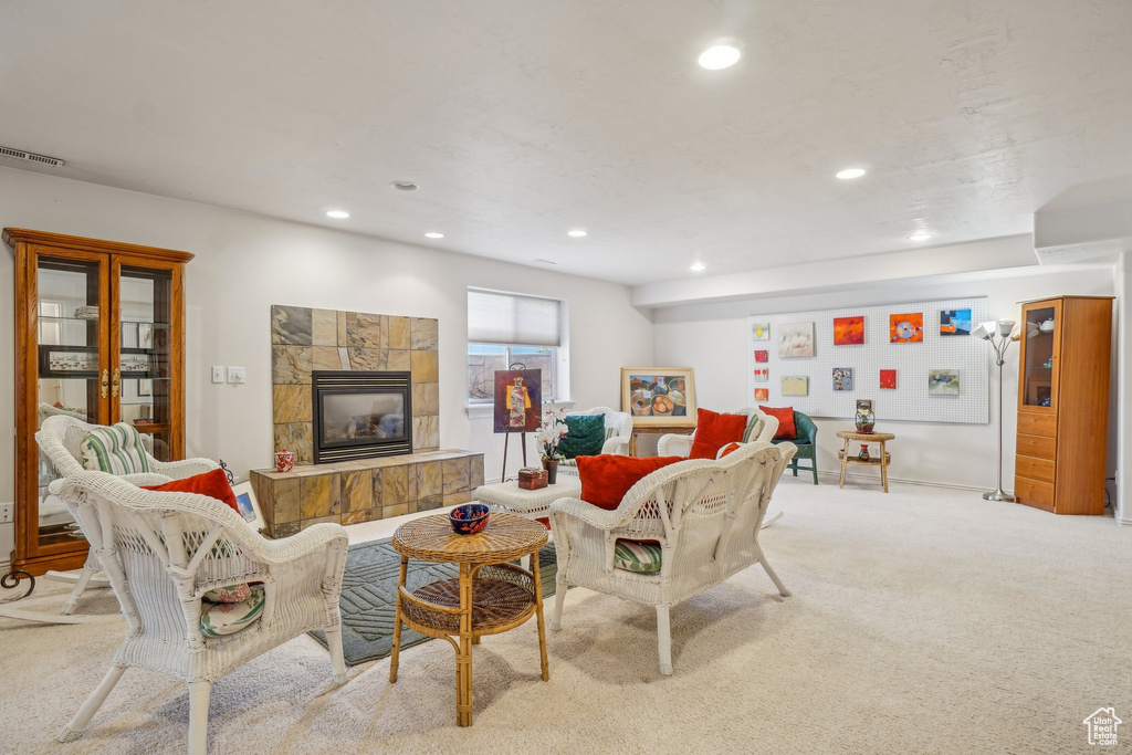 Carpeted living area with recessed lighting and a fireplace