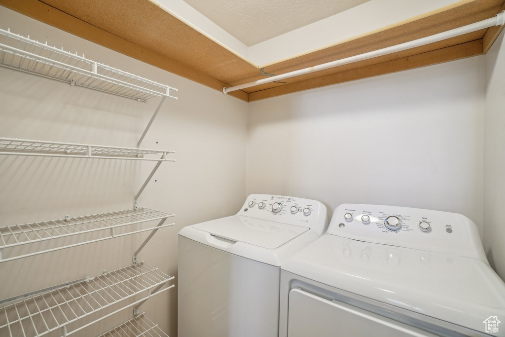 Washroom featuring washing machine and clothes dryer
