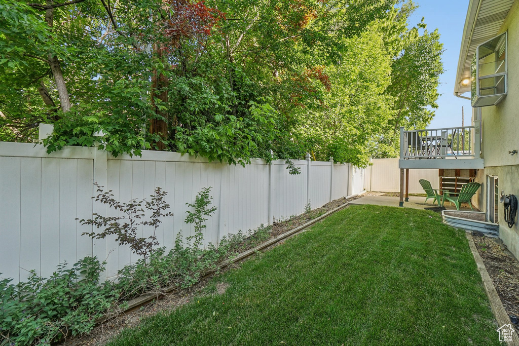 View of yard with a deck and a patio
