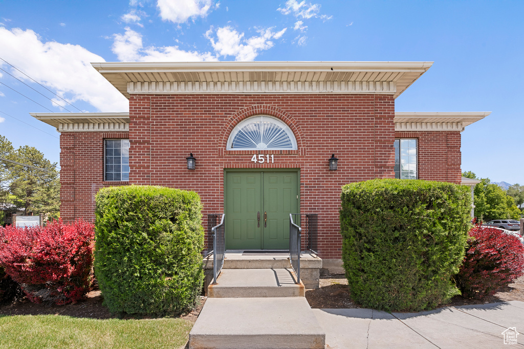 Entrance to property featuring brick siding