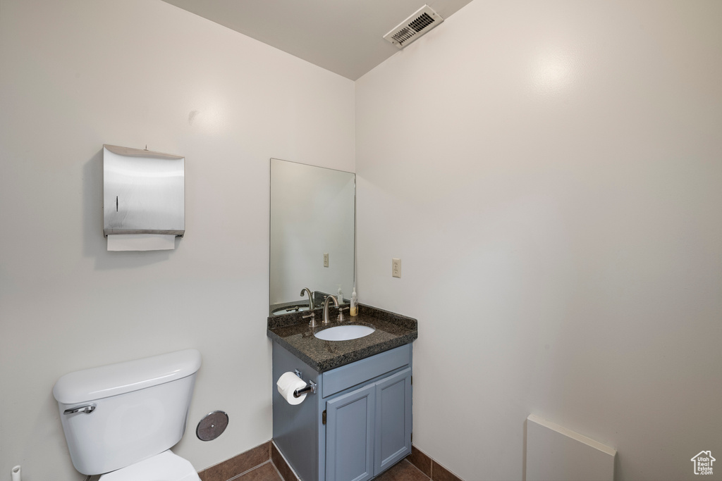 Half bathroom featuring toilet and vanity
