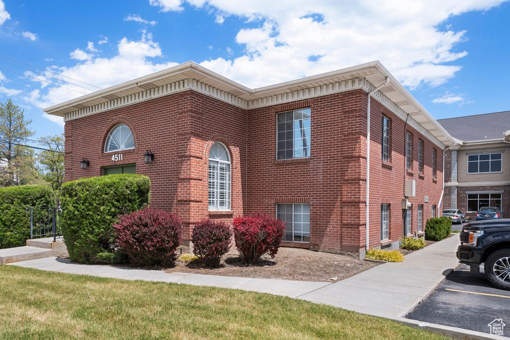 View of side of property featuring brick siding
