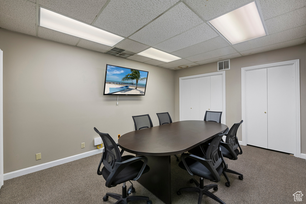 Home office with a drop ceiling, carpet, and baseboards