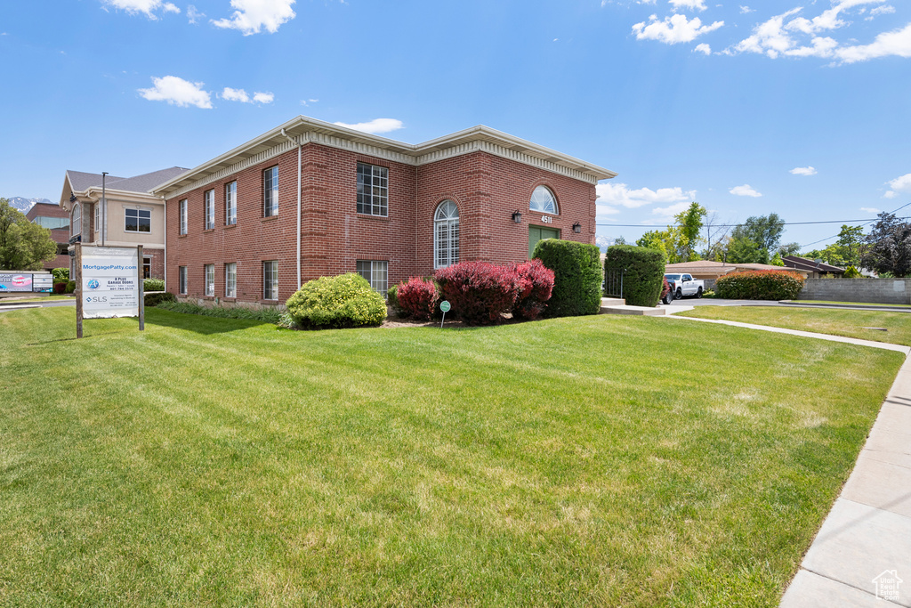View of front of home featuring brick siding and a front yard