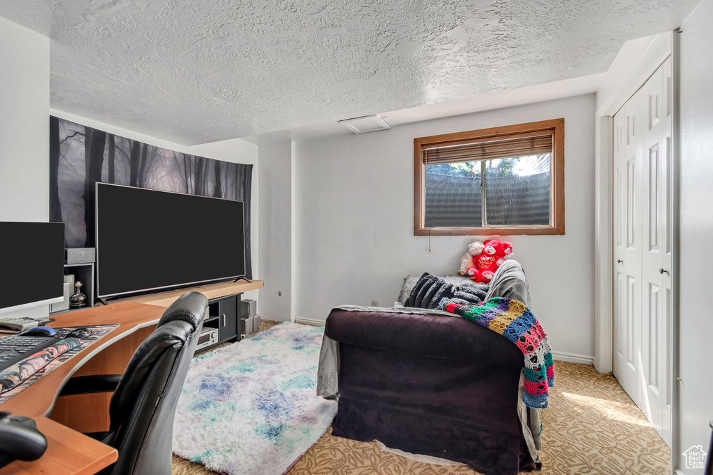Home office with a textured ceiling and baseboards