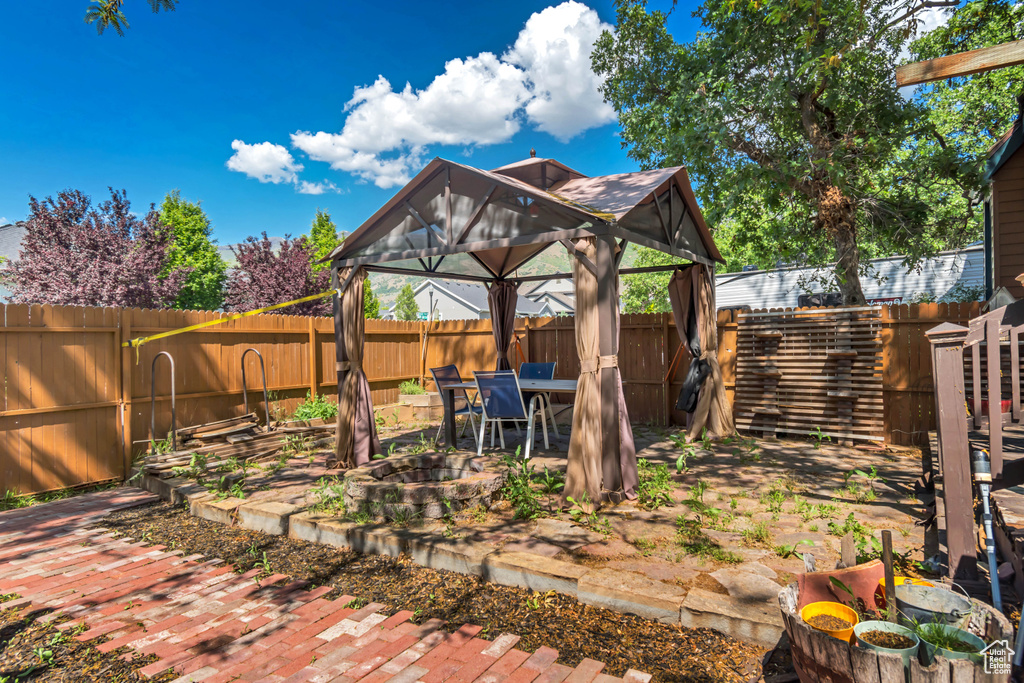 Fenced backyard with a gazebo