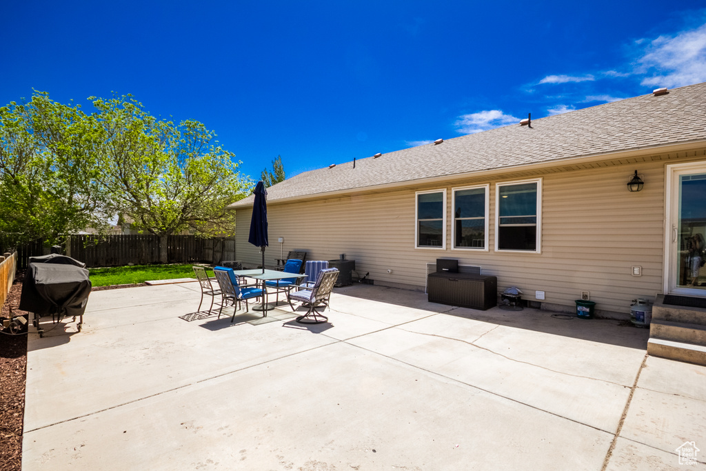 Fenced backyard with a patio and outdoor dining area