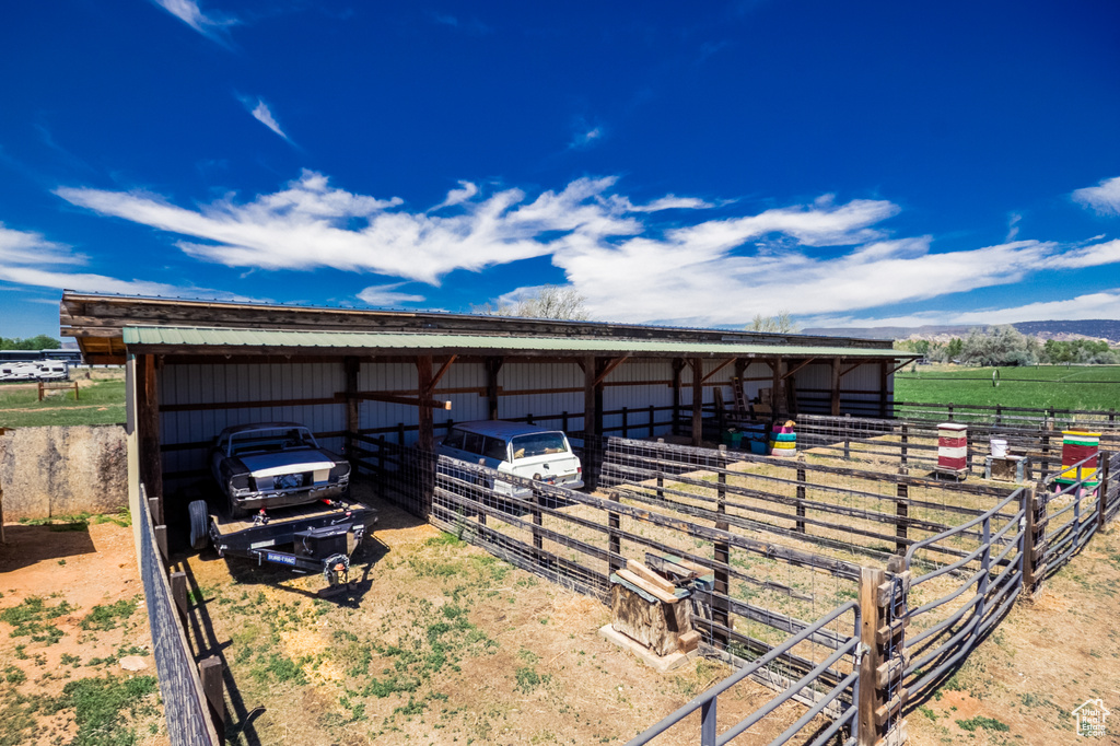 View of outdoor structure with an exterior structure, a carport, and a view of countryside
