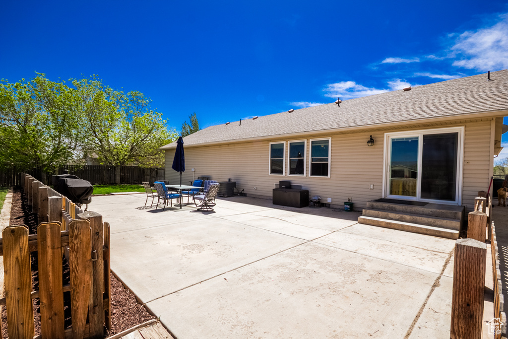 Fenced backyard with entry steps and a patio