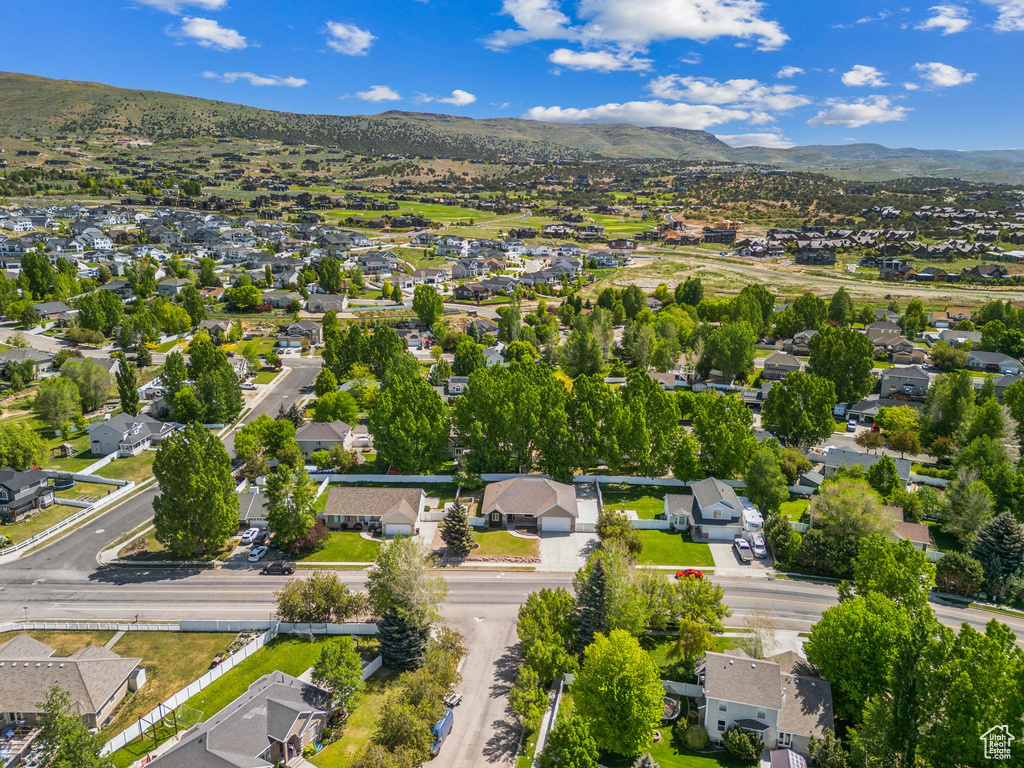 Aerial overview of property\'s location featuring nearby suburban area and mountains