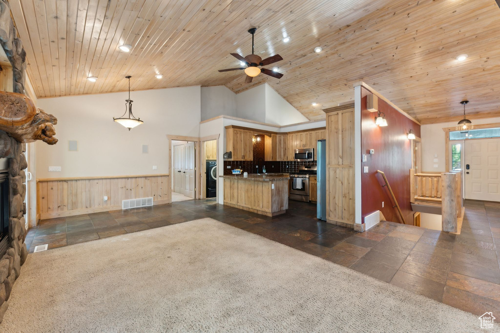 Kitchen featuring open floor plan, appliances with stainless steel finishes, ceiling fan, a wainscoted wall, and recessed lighting