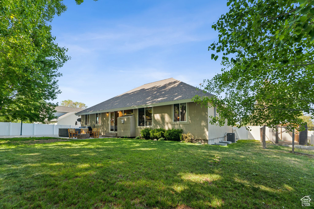 Back of property featuring roof with shingles