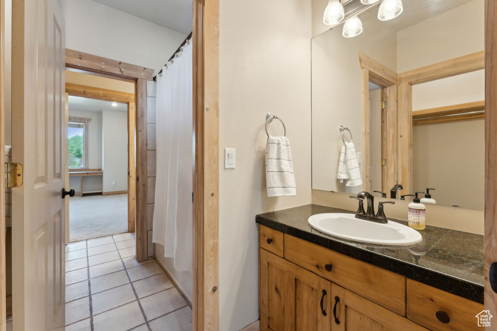 Full bathroom featuring vanity and tile patterned floors
