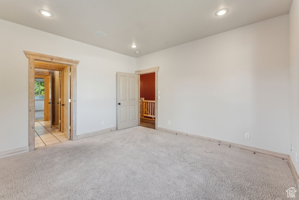 Unfurnished bedroom with carpet flooring, baseboards, and recessed lighting