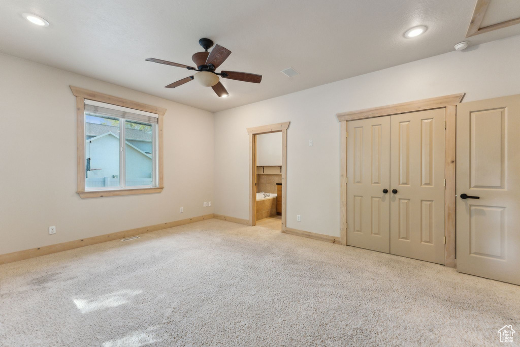 Unfurnished bedroom featuring carpet floors, baseboards, ensuite bath, ceiling fan, and recessed lighting