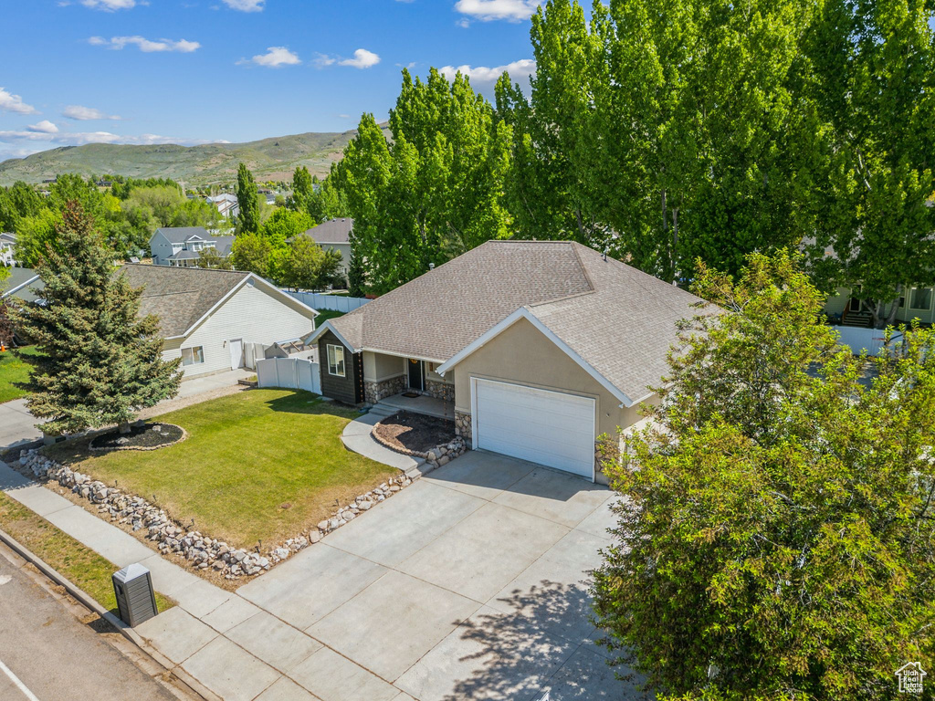 Aerial view of property and surrounding area with a mountain backdrop
