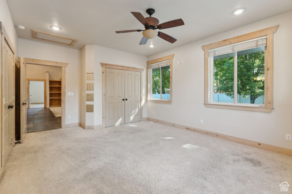 Unfurnished bedroom with attic access, carpet flooring, recessed lighting, baseboards, and a closet
