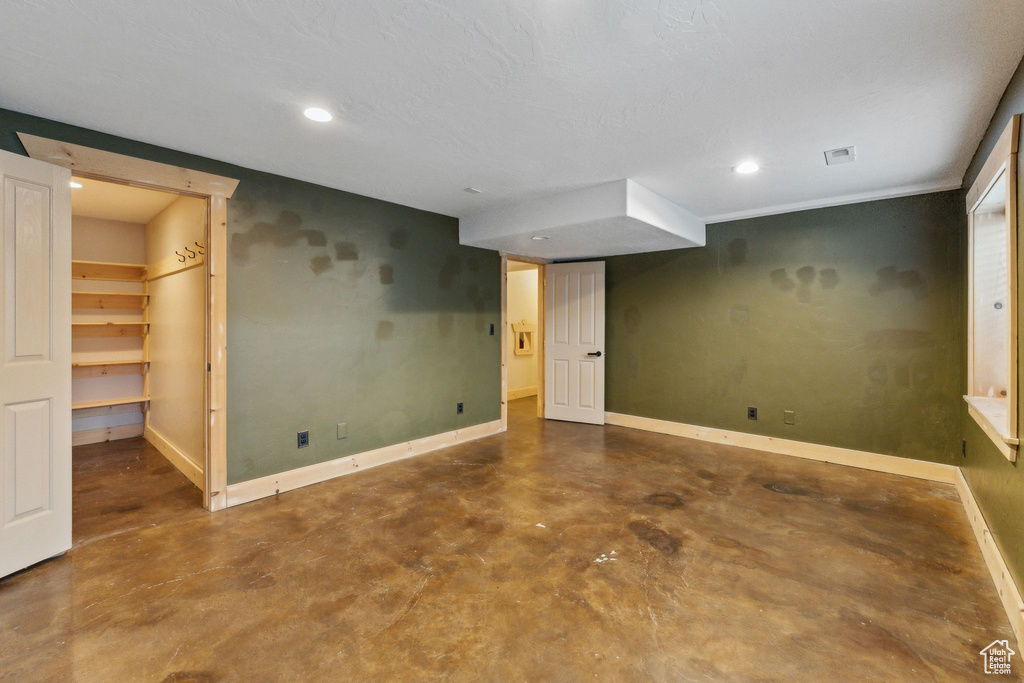 Finished below grade area featuring baseboards and recessed lighting