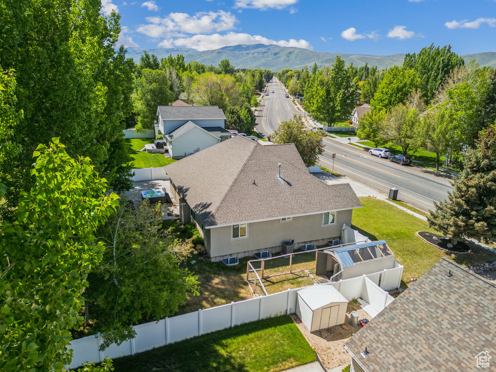 Aerial view of property and surrounding area featuring a mountain backdrop