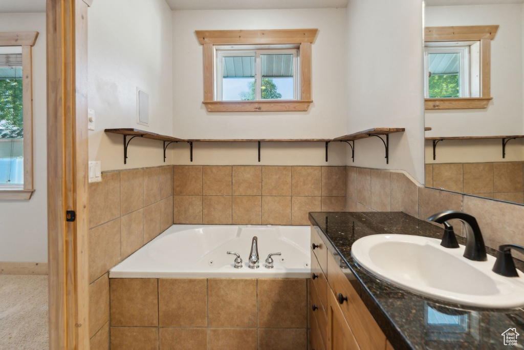 Full bath featuring vanity and a whirlpool tub