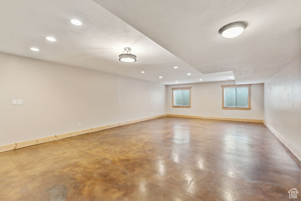 Spare room with recessed lighting, concrete flooring, and baseboards