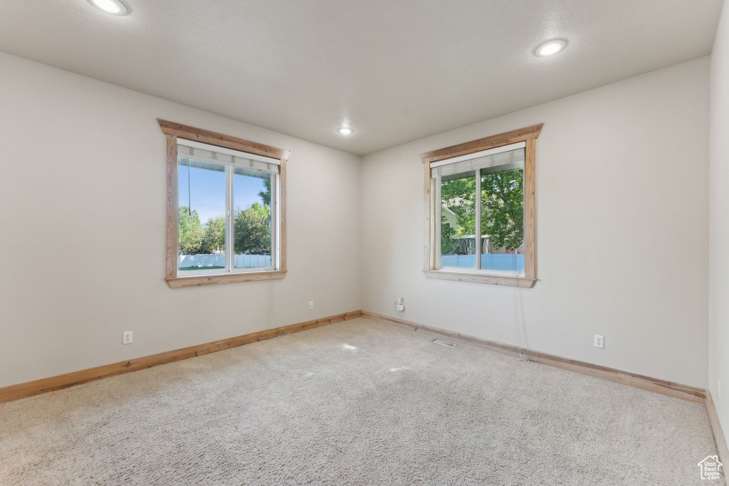 Spare room with carpet flooring, recessed lighting, and baseboards