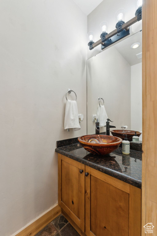 Bathroom with vanity and baseboards